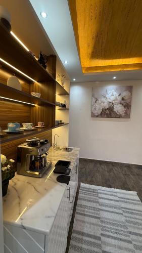 a kitchen with a counter with a stove in it at Sun Set Dunes Holidays Home