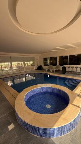 a large swimming pool with a large blue tub at Sun Set Dunes Holidays Home