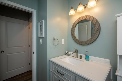 a bathroom with a sink and a mirror at Club Cottage 824 - CLARITY in Edisto Beach