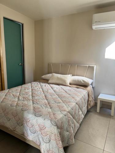 a bedroom with a bed and a green door at Amar Apartment - 24 hour security, Comfort in Tijuana