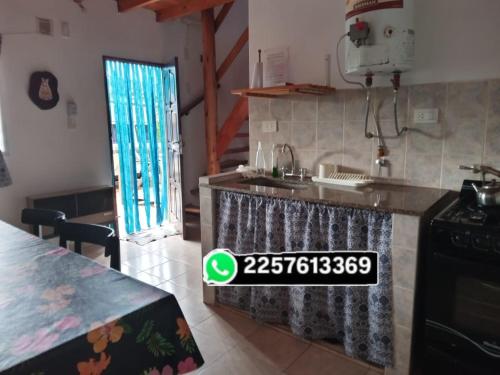 a kitchen with a counter with a sink and a stove at Es Lo Que Hay in Nueva Atlantis