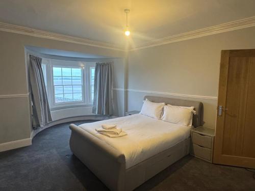 a bedroom with a bed and a window at Bay Apartment in Morecambe