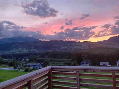 a sunset from the deck of a house at Breathtaking Voss Views - Spacious Family Home in Vossevangen