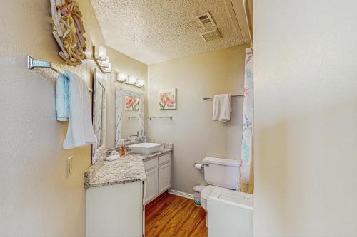 a bathroom with a sink and a toilet at Beach Club 280 in Padre Island