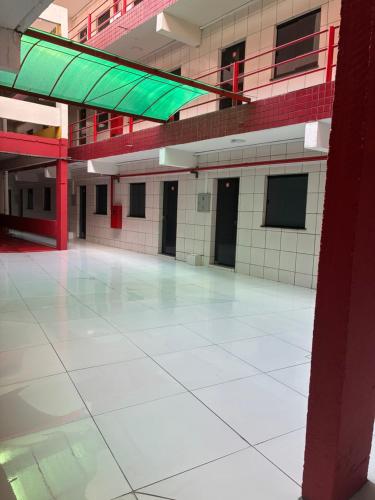 an empty building with a large white tile floor at Apartamento Flat em Belém in Belém