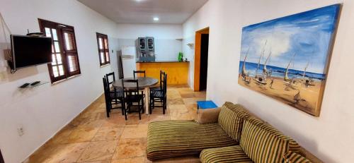 a living room with a couch and a table at Casa no Residencia Familia in Canoa Quebrada