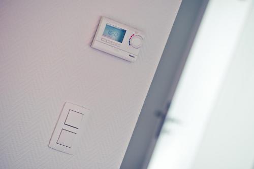 an electronic device is attached to a wall at Appart-Hotel Léopold Liège Centre in Liège