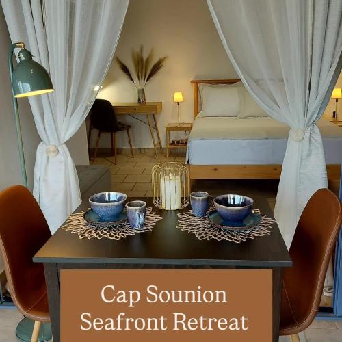 a room with a bed and a table with cups on it at Cap Sounion Seafront Retreat in Sounio