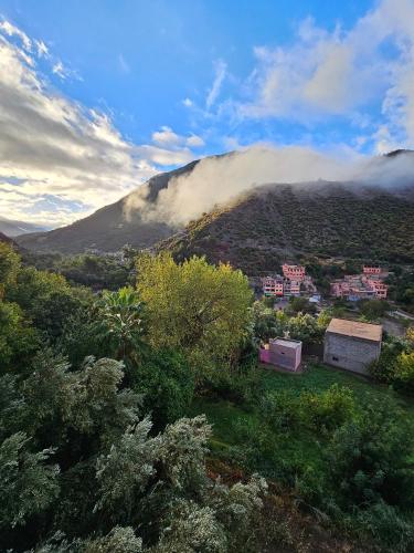 a view of a mountain with clouds in the sky at Retraite Panoramique sur l'Atlas in Ourika