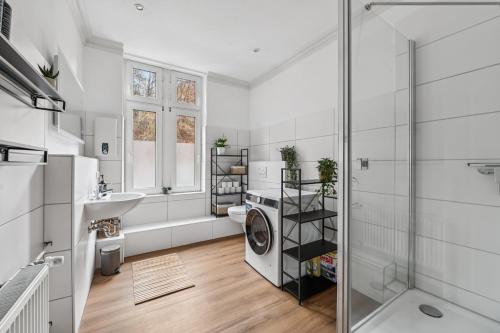 Un baño con lavadora y lavabo. en NEU! Gruppenurlaub mit Sauna im Plöner Seengebiet, en Malente