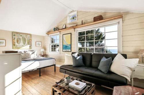 a living room with a couch and a bed at Charming Beach Cottage with Ocean Views & Sauna in Shoreline