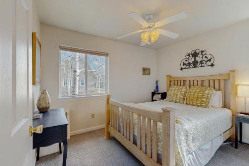 a bedroom with a crib and a ceiling fan at Recreational Paradise in Gunnison