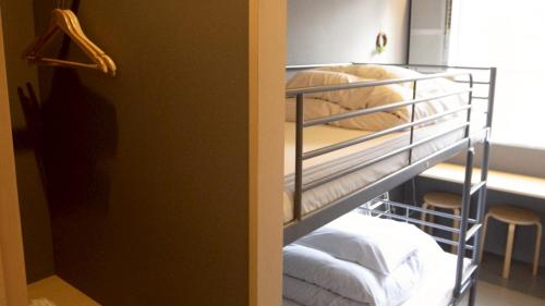 a bunk bed room with two bunk beds in a room at Little Birds Hostel in Omihachiman