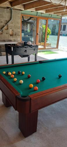 a pool table with balls on top of it at O Celeiro - Espaço Rural in Tougues