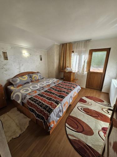 a bedroom with a large bed and a rug at La 7 Frati in Holda