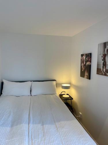 a bedroom with a bed with a white bedspread at Röda Stugan in Örby, Älvsjö in Stockholm