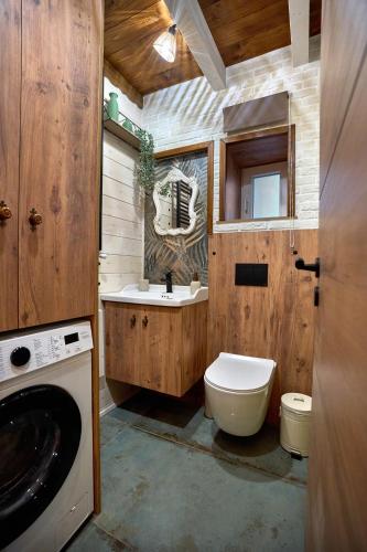a bathroom with a sink and a washing machine at Scandinavian Rustic in Tríkala