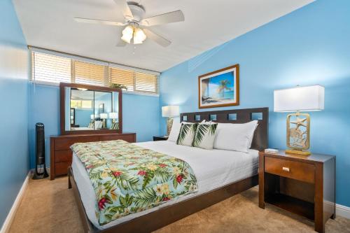 a bedroom with a bed and a ceiling fan at Kahana Reef 120 by Coldwell Banker Island Vacations in Kahana