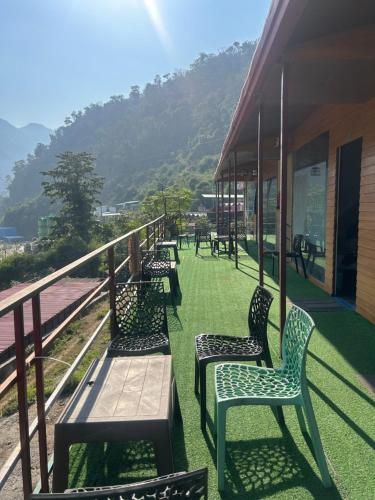 a row of benches sitting on a balcony of a building at Kaafirana Adventure Camps and Cottages in Shivpuri