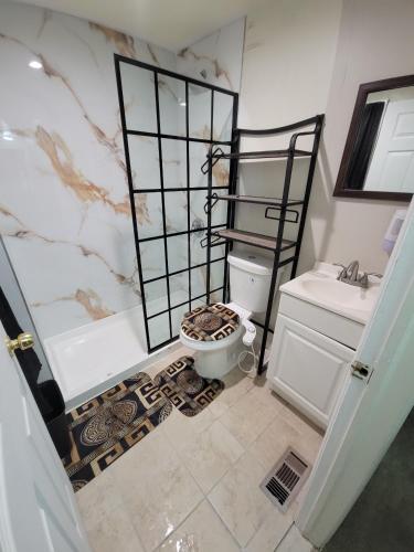 a bathroom with a tub and a toilet and a sink at Kennedy Village on Melrose Ave in Atlantic City