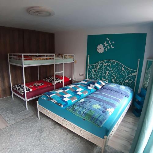 a bedroom with a bed and a bunk bed at V Domečku Jáchymov in Jáchymov