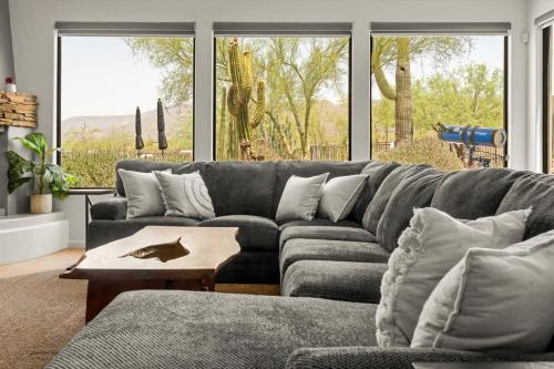 ein Wohnzimmer mit einer grauen Couch und einem Tisch in der Unterkunft Featured on StayCation-Heated Pool-Golf Course-Hot tub in New River