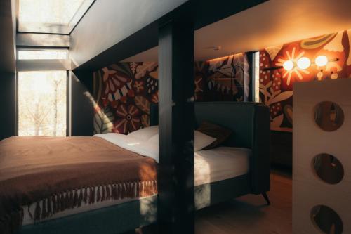 a bedroom with a bed and a window at Īves, Koka Maja in Amatciems