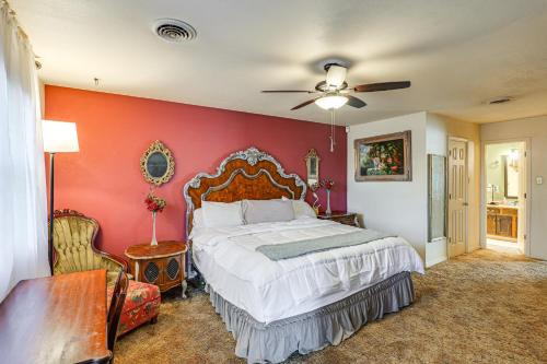 a bedroom with a bed and a red wall at 4 Mi to Dtwn The Crash Site Roswell Home! in Roswell