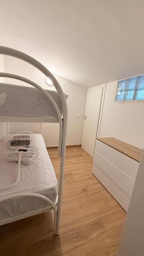 a white bed in a room with a kitchen at Nicos House in Campo di Giove