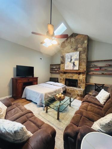 a bedroom with a bed and a stone wall at Modern Charm in Knoxville