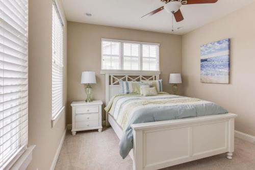a bedroom with a bed and a ceiling fan at 406A The Beach House in Virginia Beach