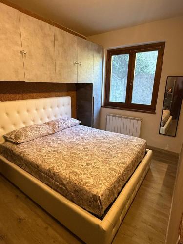 a bedroom with a bed and a window at Eden Garden in Fonteno