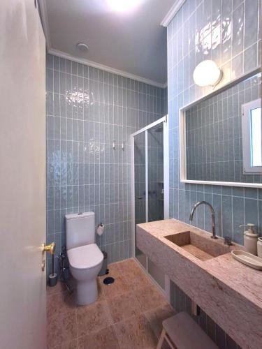 a bathroom with a toilet and a sink at Liberdade 75 Family Holiday House in Figueira da Foz