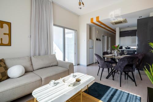 a living room with a couch and a table at Local Host Living - Signature Apartments in Nicosia in Nicosia
