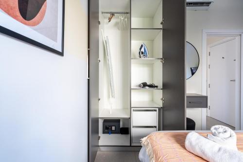 a bedroom with a bed and a mirror at Local Host Living - Signature Apartments in Nicosia in Nicosia