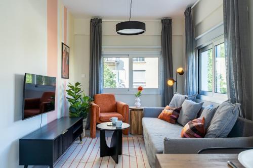 a living room with a couch and a tv at Local Host Living - Signature Apartments in Nicosia in Nicosia