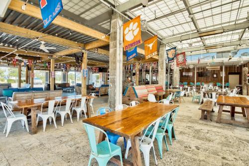 an empty restaurant with wooden tables and chairs at Prominence Southside - Blue Skies in Watersound Beach