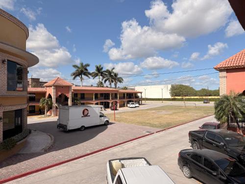 a white truck parked in front of a building at Hotel Mirage Express in Matamoros