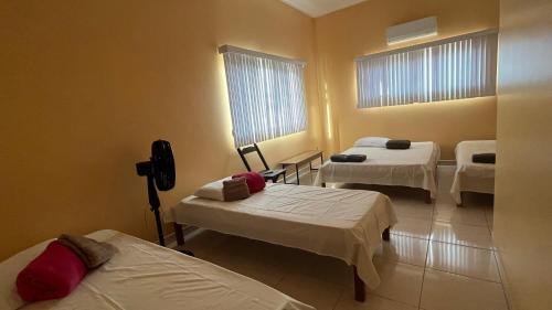 a hospital room with two beds and two windows at Espaço Dona Deja in Bom Jesus da Lapa