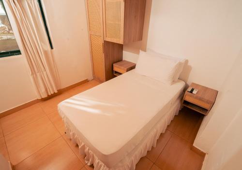 a small bedroom with a white bed and a window at Aranwa Vichayito Beach Resort in Vichayito