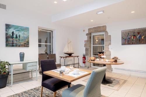 a living room with a table and chairs at Hotel Restaurant Lesage in Sarzeau