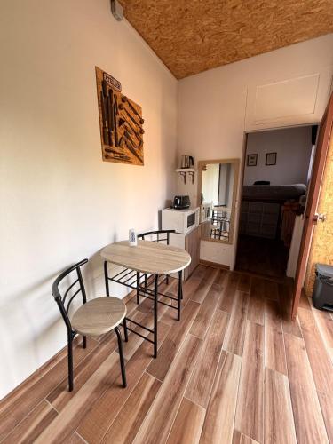 a table and chairs in a room with a kitchen at L'atelier in Festigny