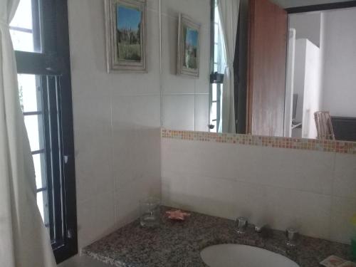 a bathroom with a sink and a mirror at Arcadia in Merlo