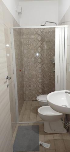 a bathroom with a shower and a toilet and a sink at la primavera in Palmi