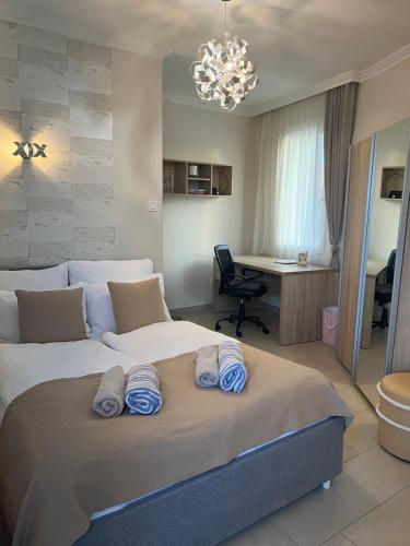 a bedroom with a large bed with blue pillows on it at Paris Yard Apartman with free parking in Debrecen