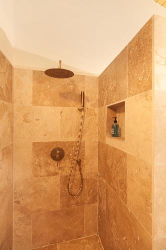 a bathroom with a shower with a shower head at Goood Resort in Kralendijk