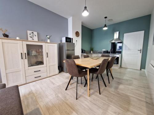 a kitchen and dining room with a table and chairs at Les appartements de Lucie in Eaux-Bonnes