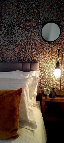 a bedroom with a bed and a mirror on a wall at Executive Apartment nr NEC, BP Pulse Live, Hampton In Arden in Hampton in Arden