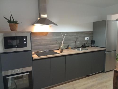 a kitchen with a sink and a stove top oven at O Caminho Azul in Olivenza