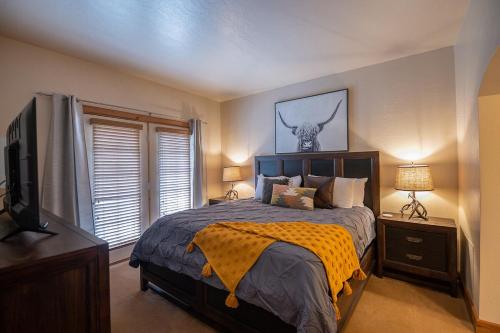 a bedroom with a bed with a cow head on the wall at Alpine-Style Zermatt King Villa with Full Kitchen Near Park City & Deer Valley Ski Resorts - 2068 in Mound City